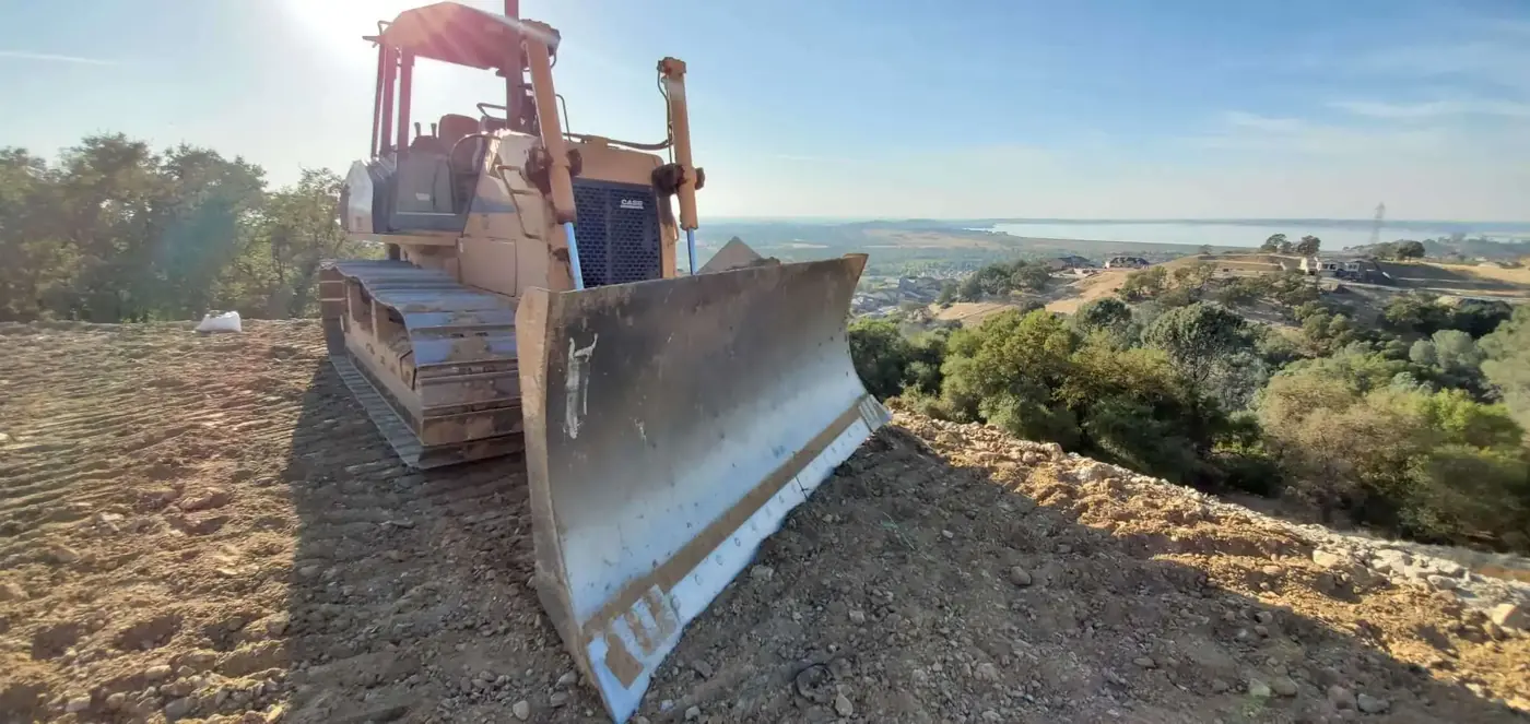 A dozer working a lot raised to grade above the surrounding ground